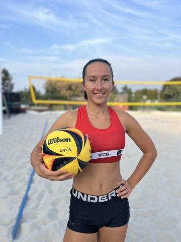 Denisa smiling in her red jersey