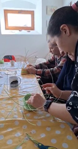 Denisa weaving a basket at a community workshop