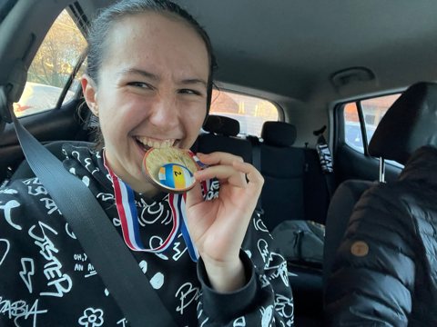 Denisa celebrating with a medal