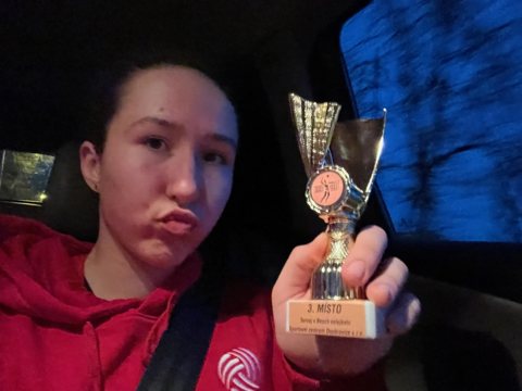 Denisa holding a tournament trophy