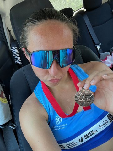 Denisa wearing a medal and sunglasses