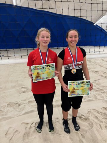 Volleyball teammates with medals and certificates