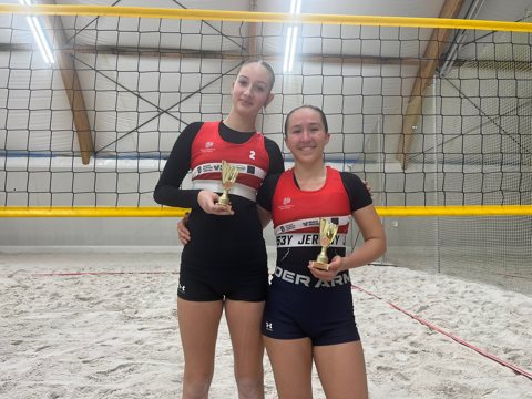 Volleyball teammates with tournament awards